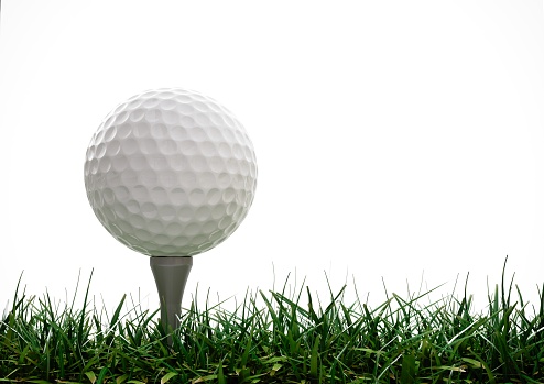 Golf ball with tee in the grass on white background