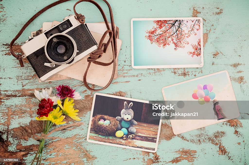 spring photo album Photo album in remembrance and nostalgia of Happy easter day in spring on wood table. instant photo of vintage camera - vintage and retro style Easter Stock Photo