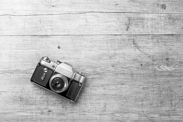 istock top view of retro camera on wooden table 637982160