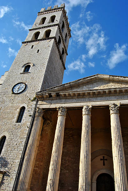 Santa Maria Sopra Minerva in Assisi (Italy) Medieval town hall tower and facade of Santa Maria Sopra Minerva, ancient church of Assisi (Italy) build over a roman age temple umbria architecture assisi corinthian stock pictures, royalty-free photos & images