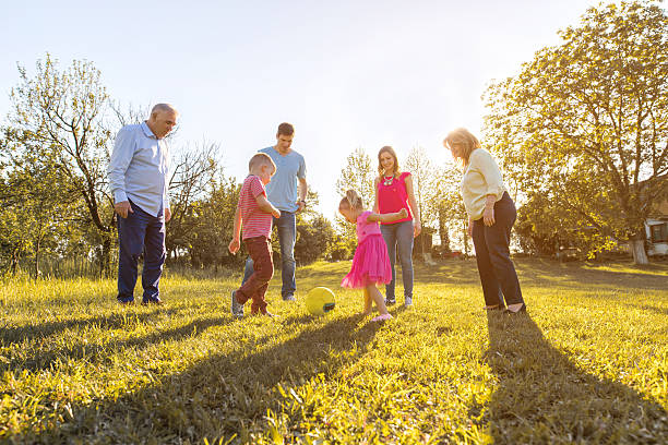 istock Multi-generation family playing with ball together in nature. 637985718