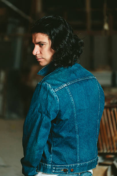 istock handsome man with long hair brunette in a denim jacket 637986268