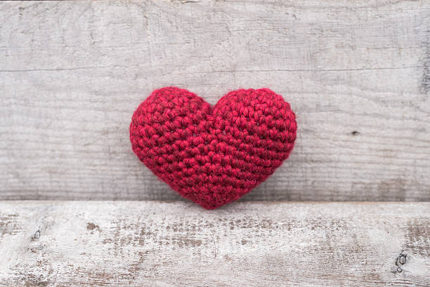istock Crocheted heart on a grunge background 637988496