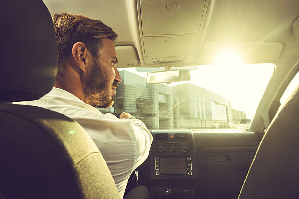 istock Young businessman going on a business trip by car. 637988690