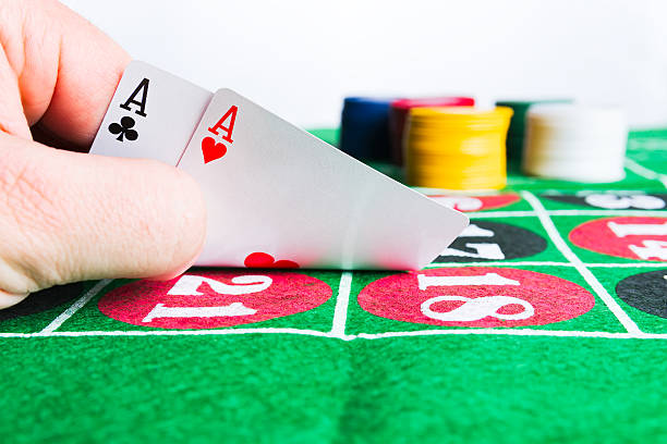 istock Two aces with chips on green casino table. 637988838