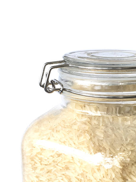 istock close up rice in the glass jar ,isolated on white 637989538
