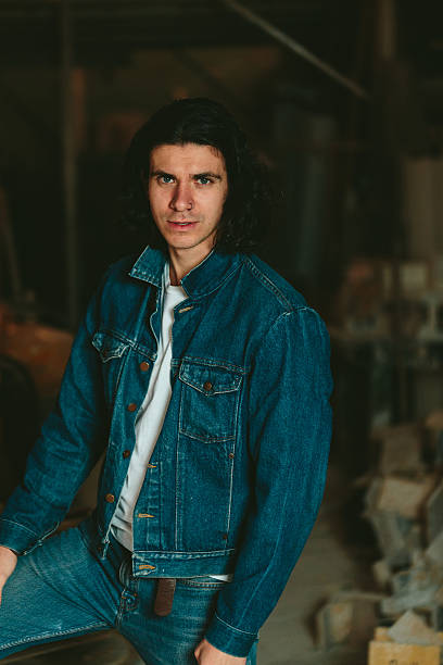 istock handsome man with long hair brunette in a denim jacket 637990696