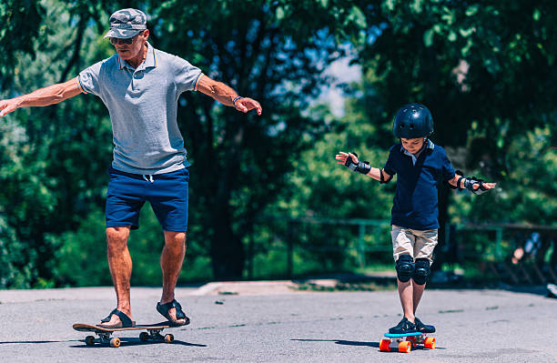 istock Grandfather and grandson trying skateboards 637991864