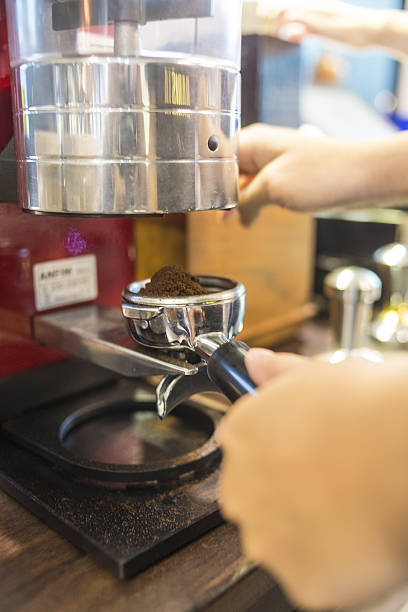 istock barista making coffee in the cafe with coffee machine 637992276