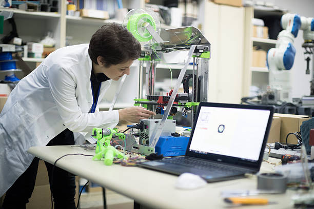 istock Woman repairing 3D printer 637999946