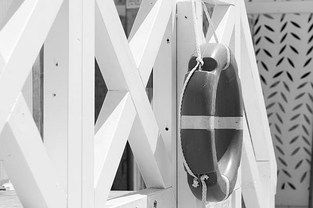 lifesaver hanging from a white beach cabinlifesaver iun a beach in the Mediterranean
