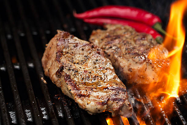 istock pork steak on bbq grill with flame 638001700
