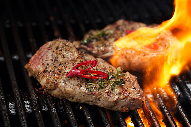 istock pork steak on bbq grill with flame 638002134