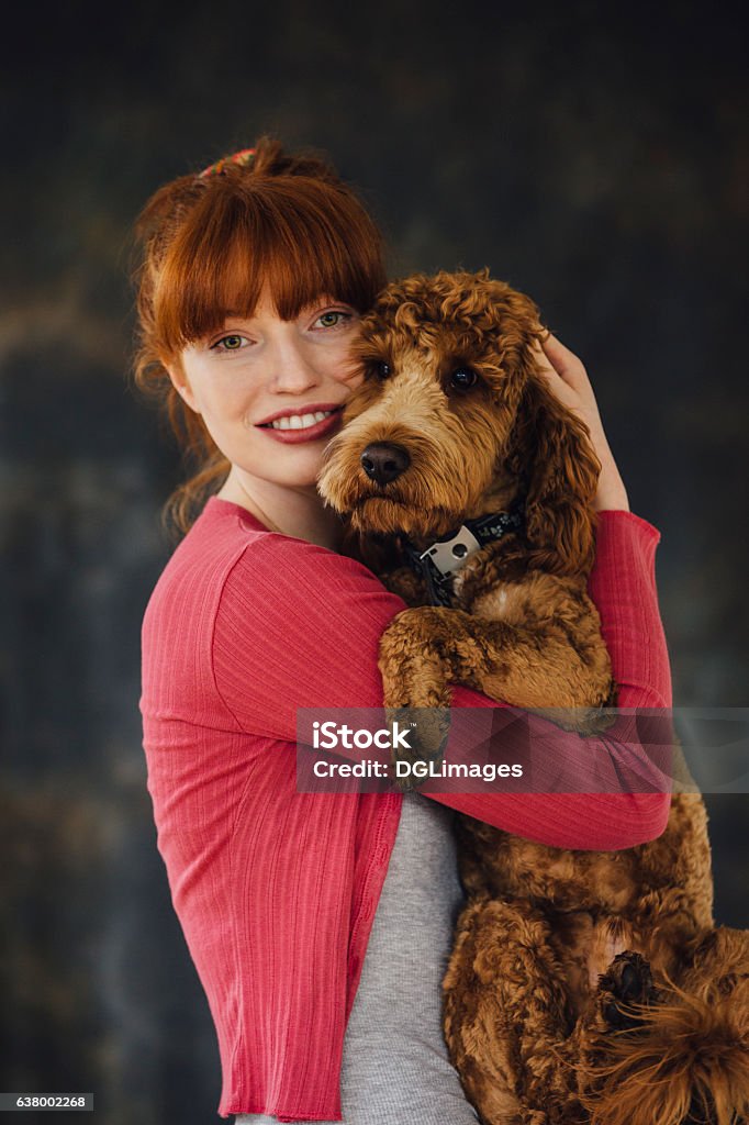 My Pet Looks Like Me Woman posing with her pet dog in her arms. Dog Stock Photo