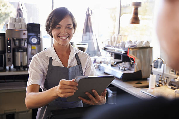 istock Cashier Takes Card Payment From Customer With Digital Tablet 638005036