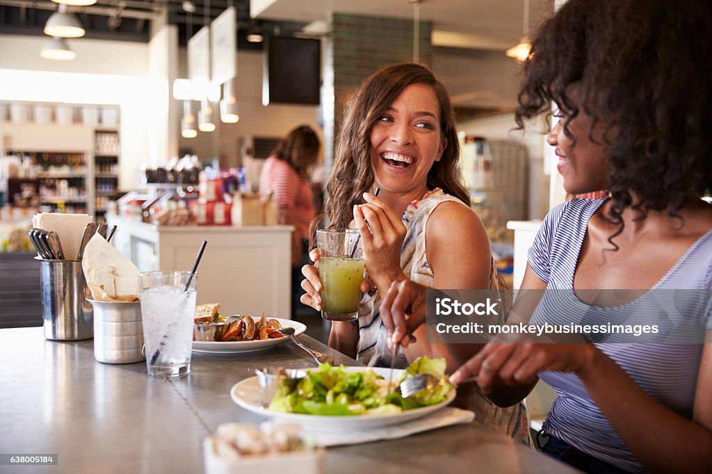 Two Women Enjoying Lunch Date In Delicatessen Restaurant Restaurant Stock Photo