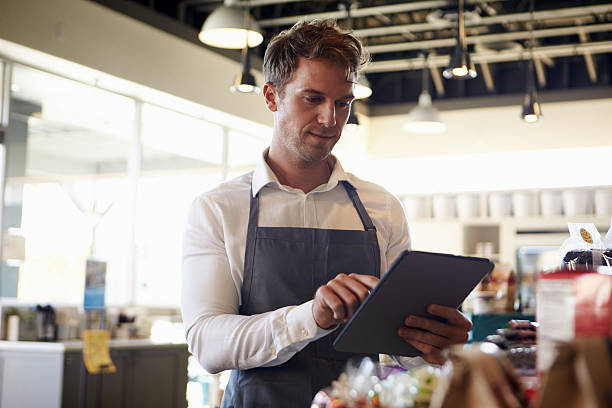 istock Employee In Delicatessen Checking Stock With Digital Tablet 638005478