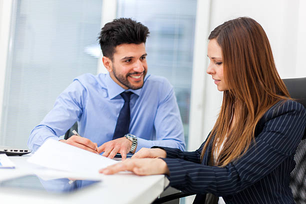 istock Two young business partners discussing plans or ideas at meeting 638006782