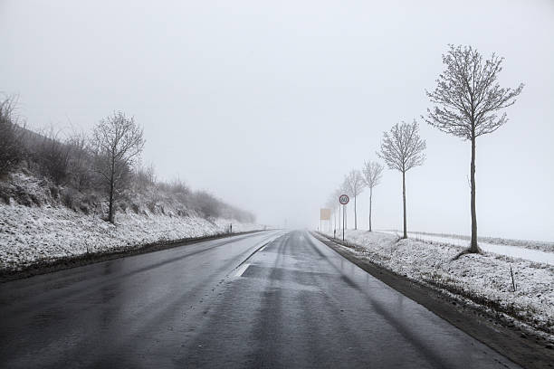 istock Federal road, snow and fog 638007612