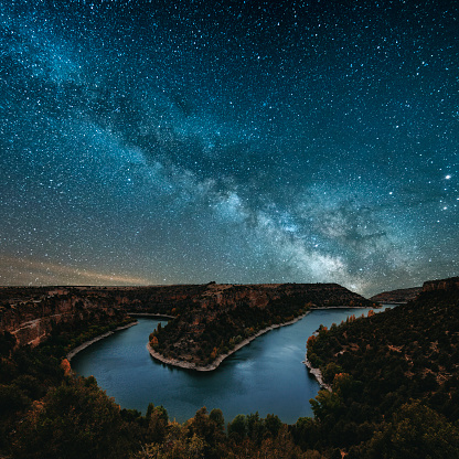The milky way by a canyon river