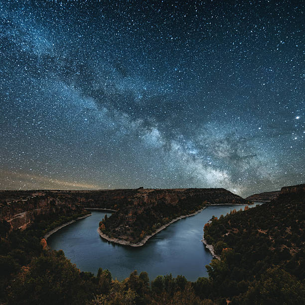 Milky way by the river The milky way by a canyon river scientific exploration stock pictures, royalty-free photos & images
