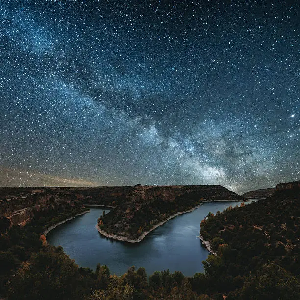 The milky way by a canyon river
