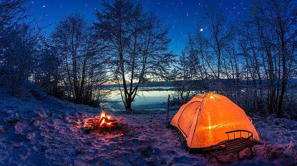 sonnenaufgang auf wintersee in der dämmerung mit schnee bedeckt - lake night winter sky stock-fotos und bilder