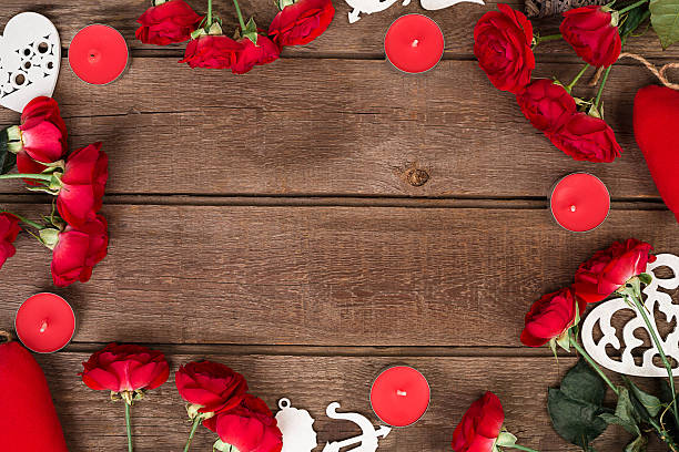 istock Red roses, candles and hearts over wood with copy space 638010672