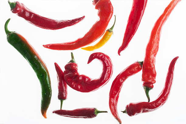 istock Green, yellow and red chili peppers isolated on white background 638010874