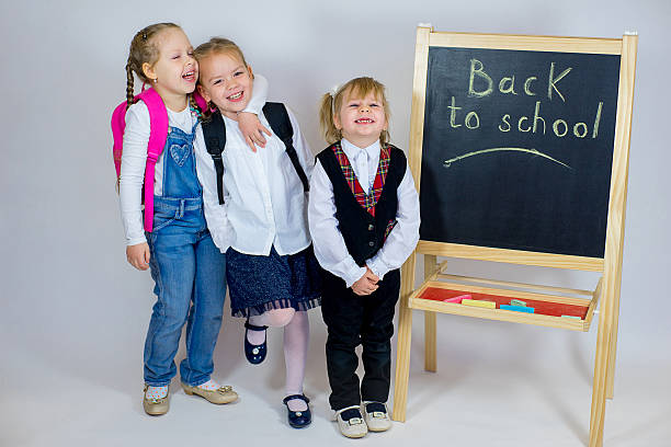 istock three young schoolgirls near the blackboard 638012404