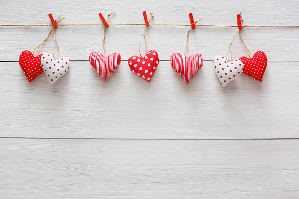 istock Valentine day background, pillow hearts border on wood, copy space 638012426