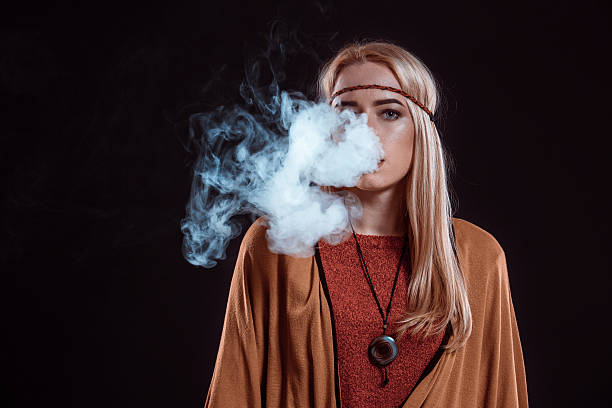 istock Young woman in the Boho style blowing smoke 638013118