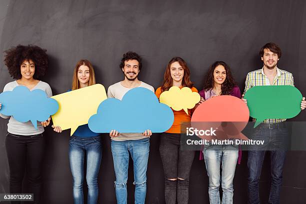 Happy Friends Holding Speech Bubbles Stock Photo - Download Image Now - Breaking the Ice, Thought Bubble, People