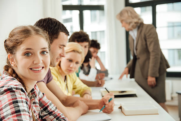 istock Portrait of smiling university student in classroom 638016010