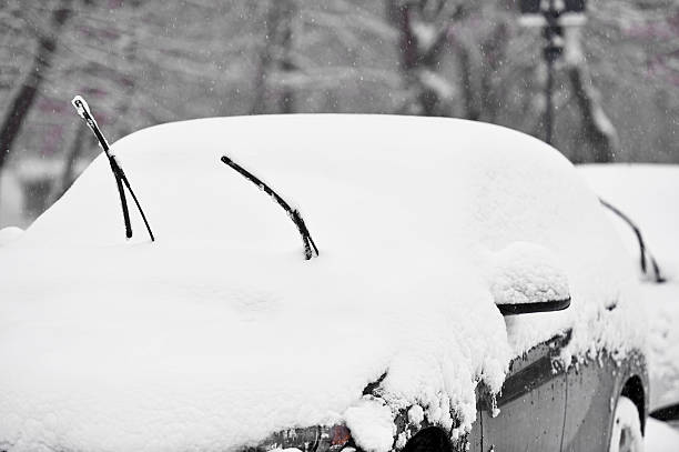 istock Windshield wipers of an snow covered car 638016020