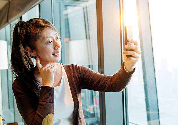 istock Young asian woman using smart phone 638021568