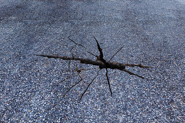 istock close up of crack on asphalt road 638021608