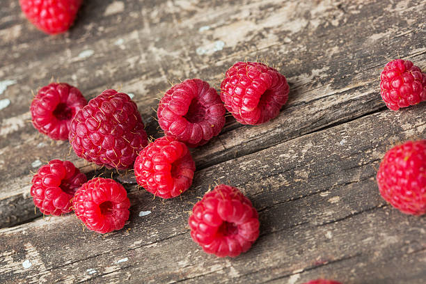 istock Raspberries on vintage wooden boards 638024882