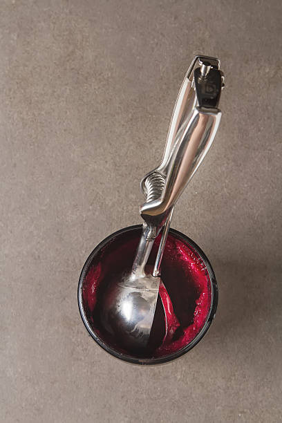 istock Spoon ice cream with red sorbet lies gray table. 638027152