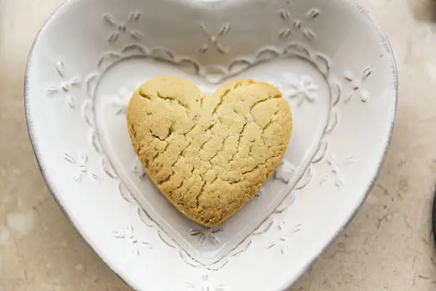 tasty homemade Cookie in the shape of a heart on aheart plate .top view.Valentin.s day concept. with love
