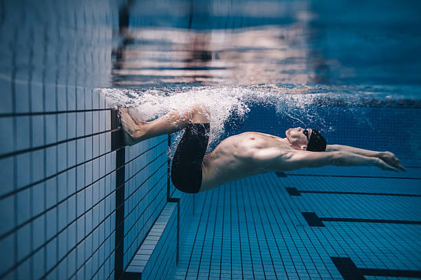 istock Pro male swimmer in action inside swimming pool 638028192