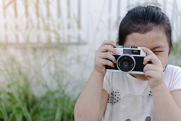 istock Little kid holding camera and taking photo. 638029548