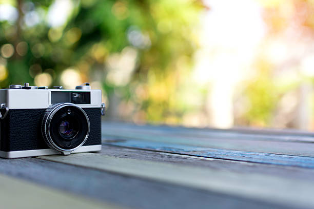 istock Retro camera on wood table background, vintage color tone 638031454