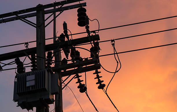 istock Sunset and silhouette of electrical transformer on pole 638032834