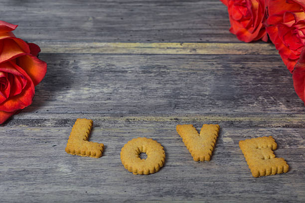 istock Cookies with roses on the wooden background 638035242