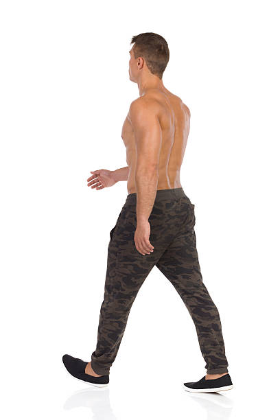 istock Walking Half Naked Man In Camo Pants Rear View 638036336