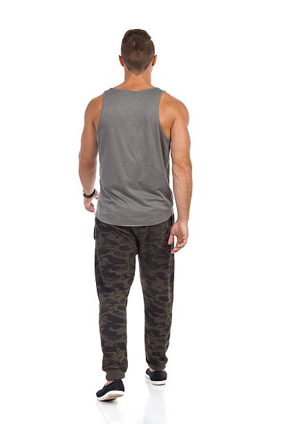 istock Walking Man In Camo Sweat Pants Rear View 638036412