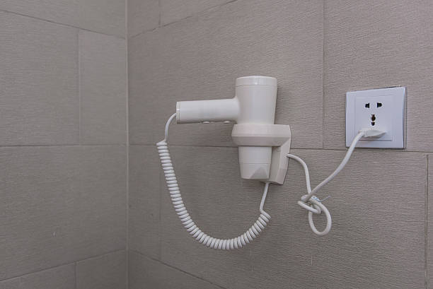istock Hair dryer hanging on wall in bathroom 638037334
