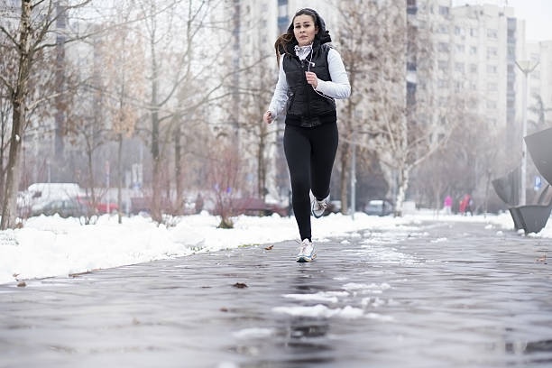 istock Young woman running in a winter day 638039332