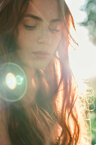 istock Beautiful redhead girl in sun rays 638039982